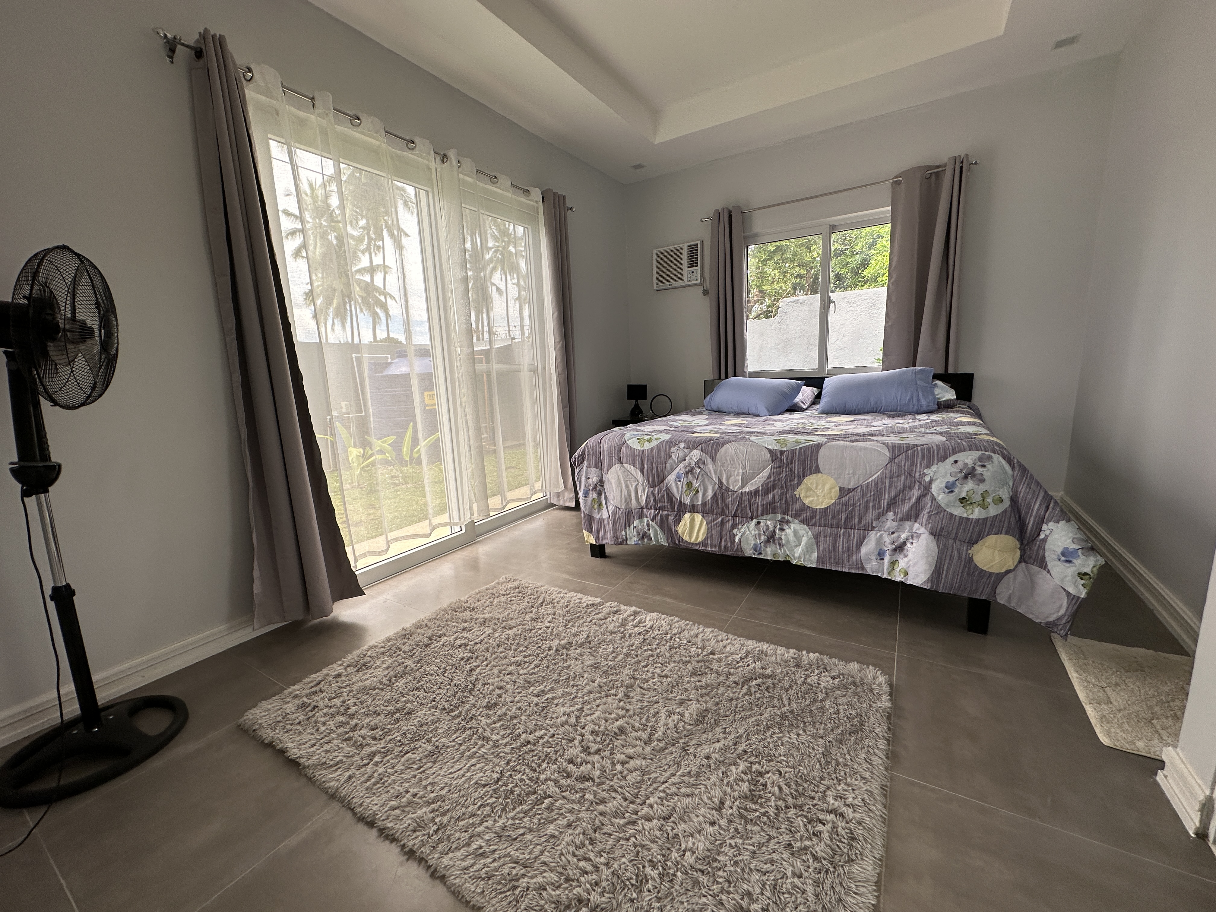 Bedroom with sliding door and palms