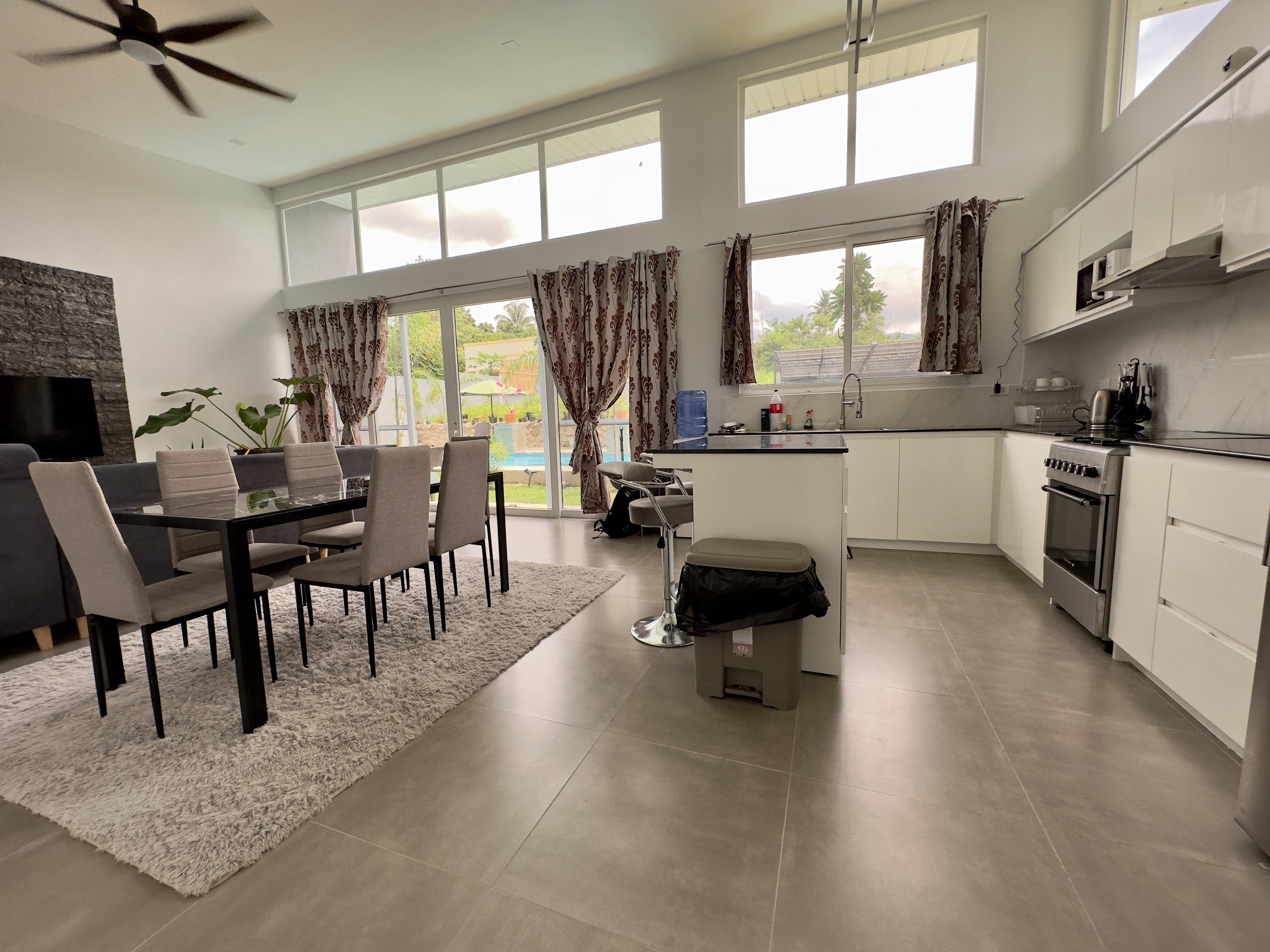 Open living, dining and kitchen looking through to the pool
